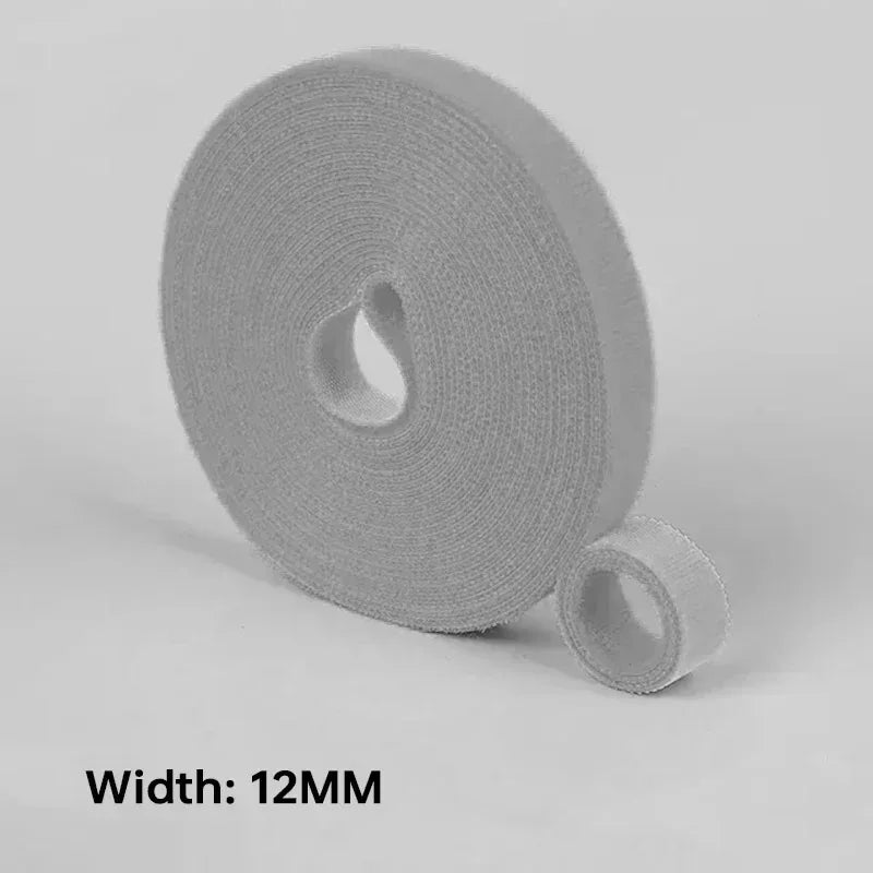 Roll of grey cable tie with a smaller section peeled off on a light gray background, labeled 'Width: 12MM'.