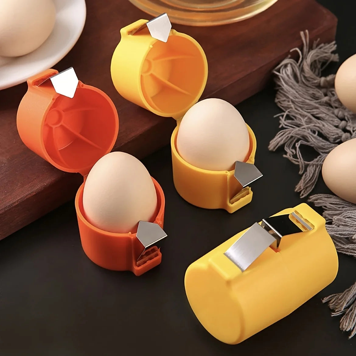 Egg holders in orange and yellow on a dark surface with eggs.